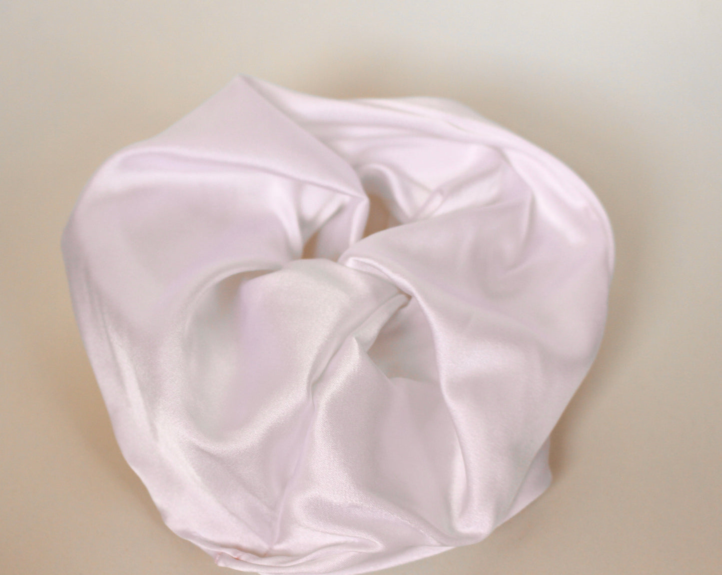 Goose Summer is a small, sustainable plant dyeing business making naturally dyed silk scrunchies and other accessories in Los Angeles. Big, white silk scrunchie hand sewn in LA by Goose Summer.
