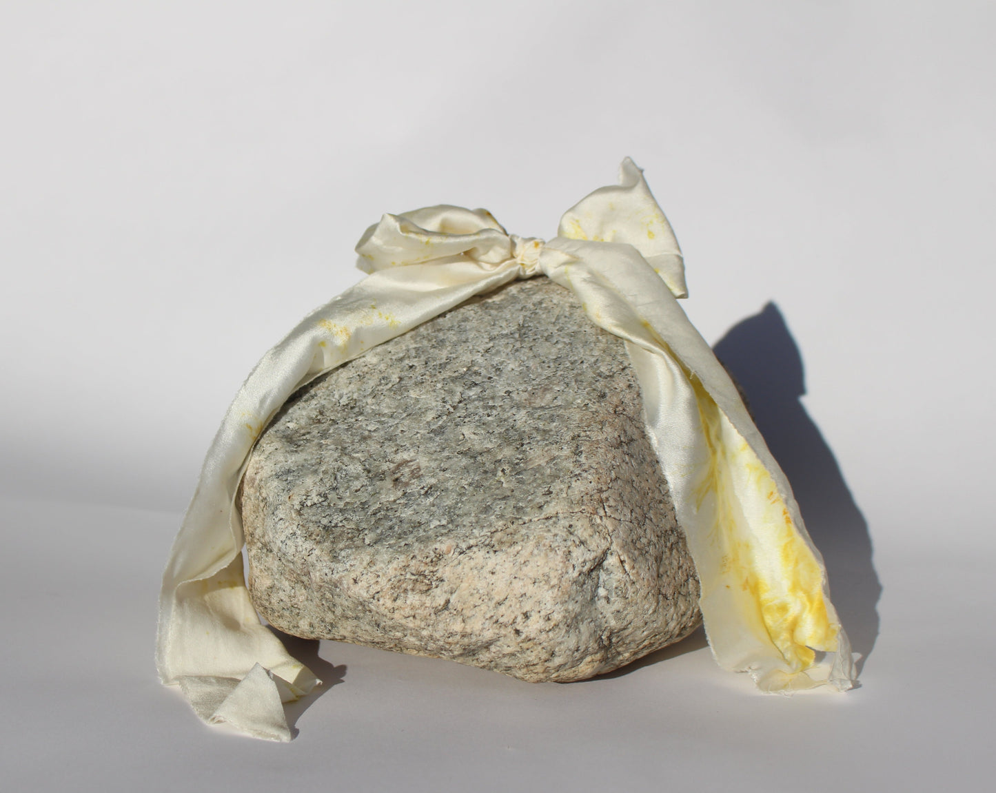 White with yellow flower pattern on a silk bow