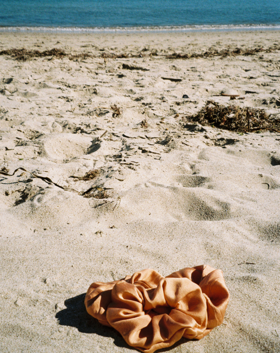 Three silk scrunchies on the beach