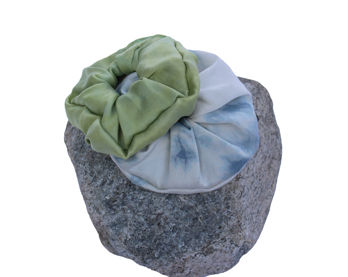 Green and blue silk scrunchies on a rock