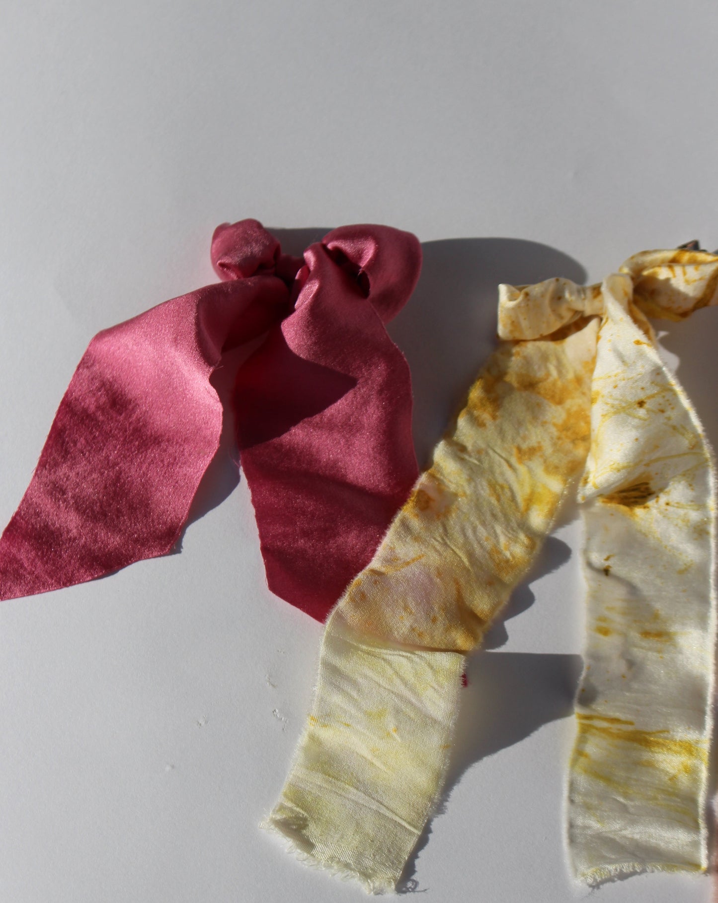 A yellow and pink silk bow