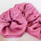 Goose Summer is a small, sustainable plant dyeing business making naturally dyed silk scrunchies and other accessories in Los Angeles. Three fuchsia colored plant dyed silk scrunchies made by Goose Summer.