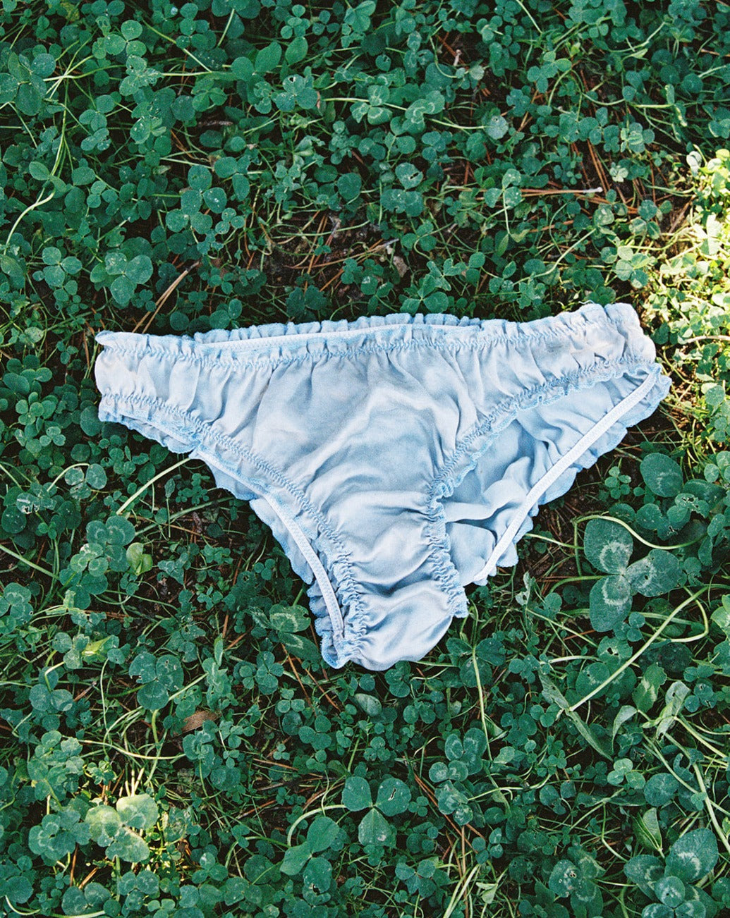Indigo Blue Silk Woman's underwear lying in the grass
