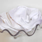 Goose Summer is a small, sustainable plant dyeing business making naturally dyed silk scrunchies and other accessories in Los Angeles.  White silk scrunchies displayed in a clear glass seashell bowl.
