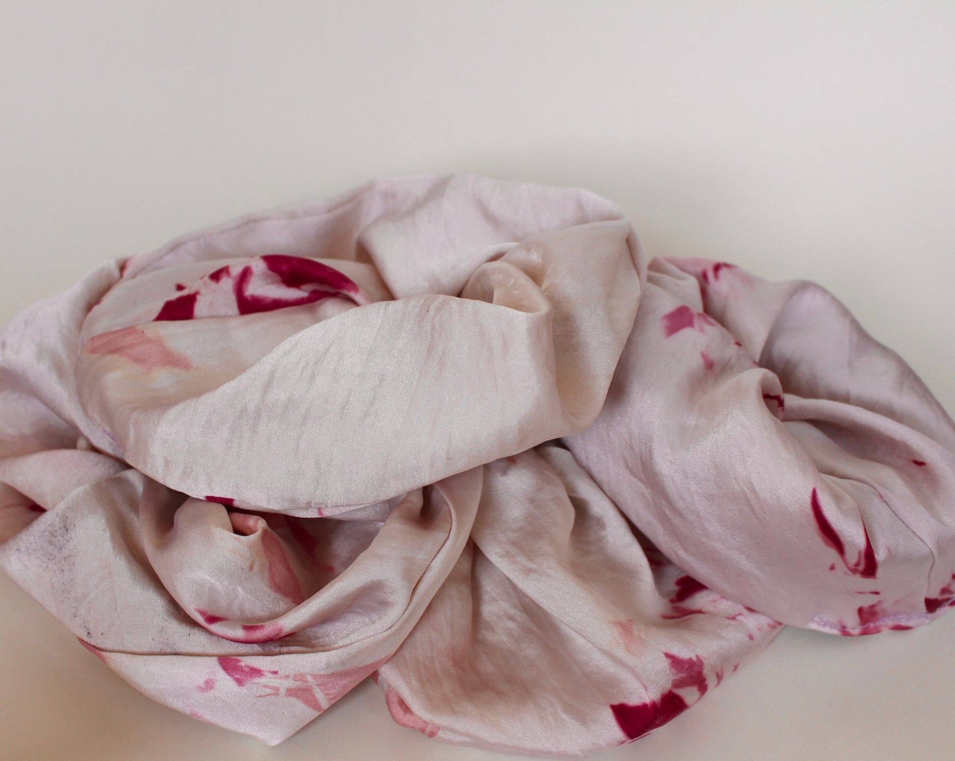 Goose Summer is a small, sustainable plant dyeing business making naturally dyed silk scrunchies and other accessories in Los Angeles. Pink tie dyed plant dyed silk scrunchies made by Goose Summer.