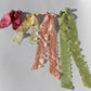 Four silk plant dyed bows