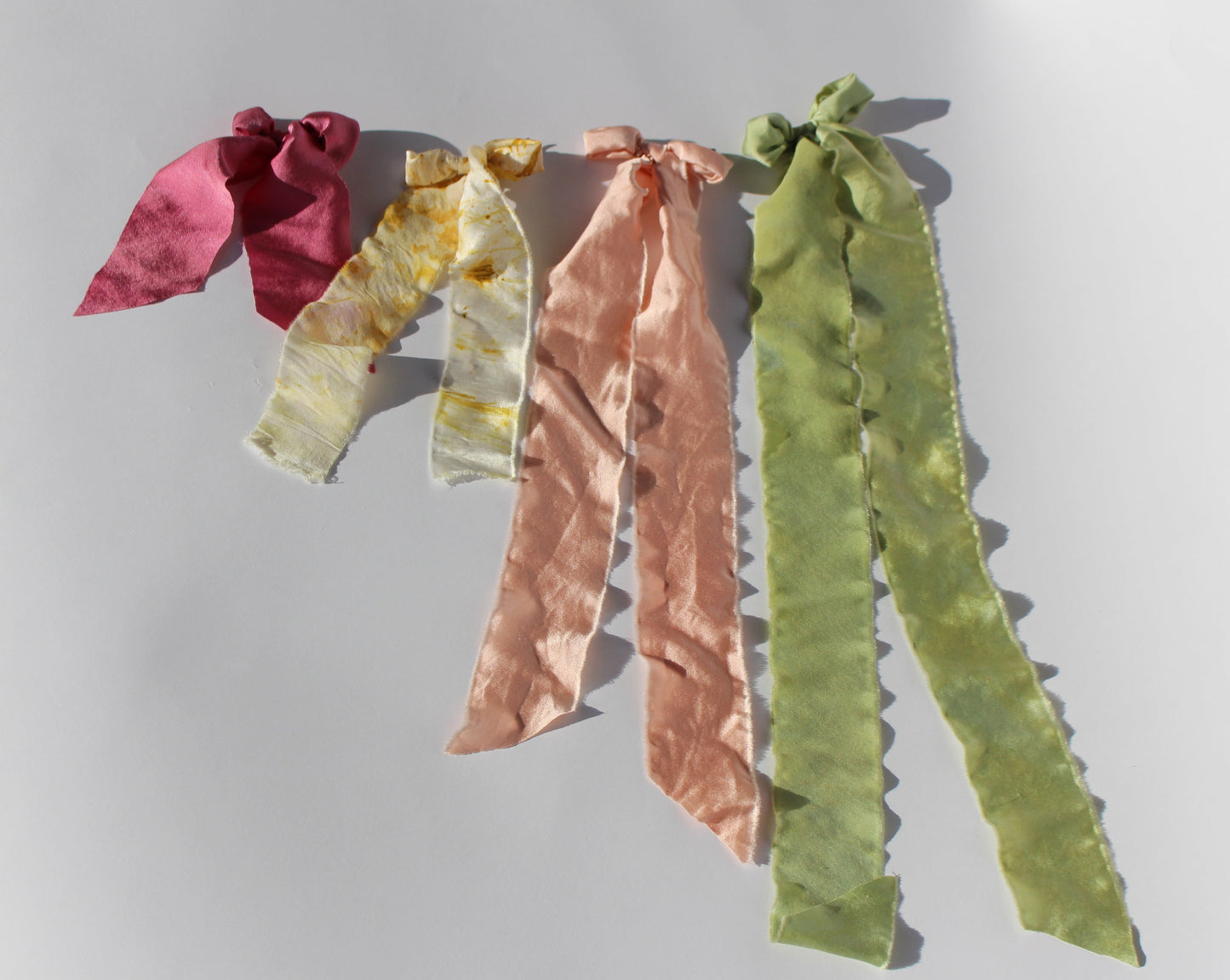 Four silk plant dyed bows