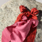 red and pink silk bows on a rock