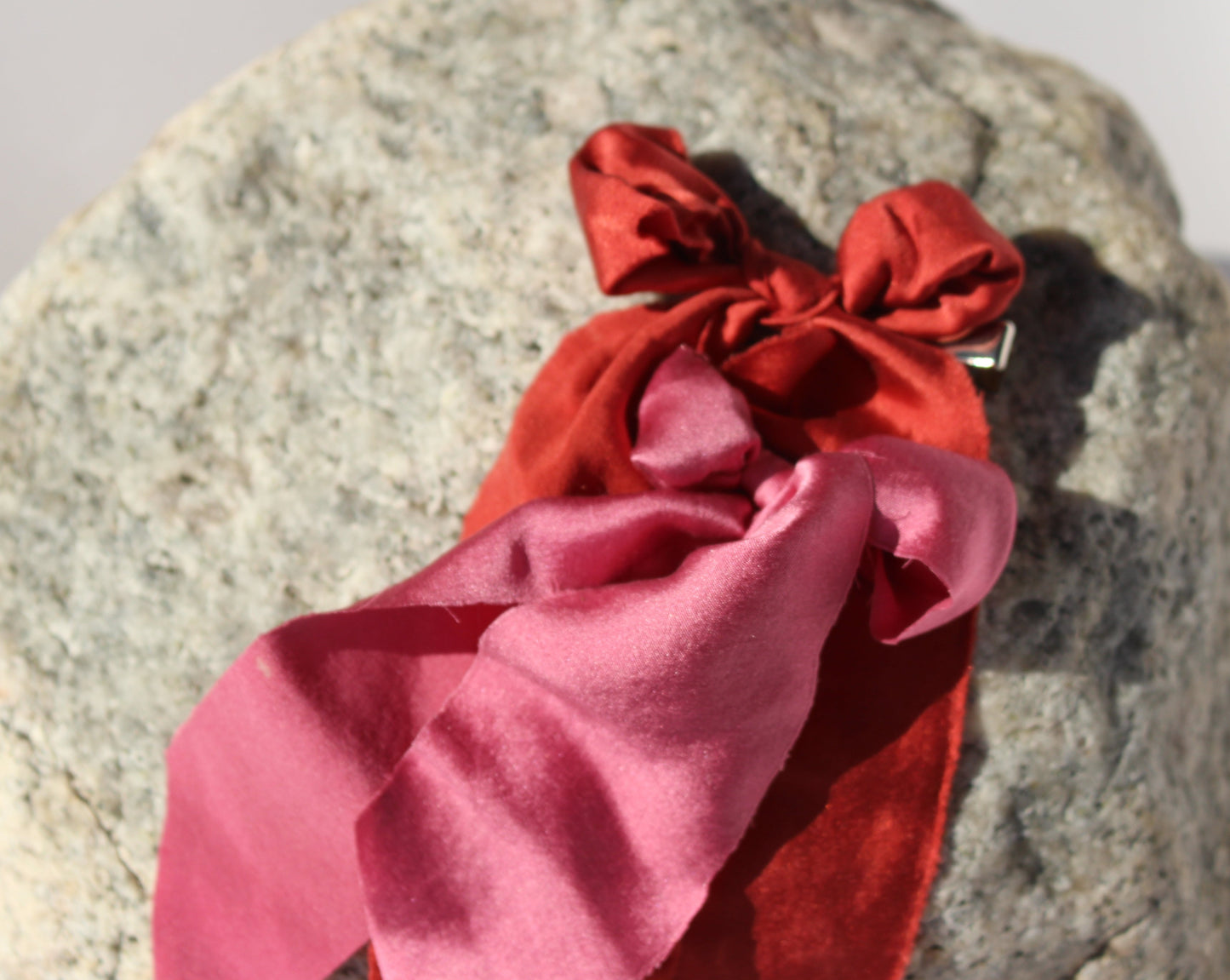 red and pink silk bows on a rock