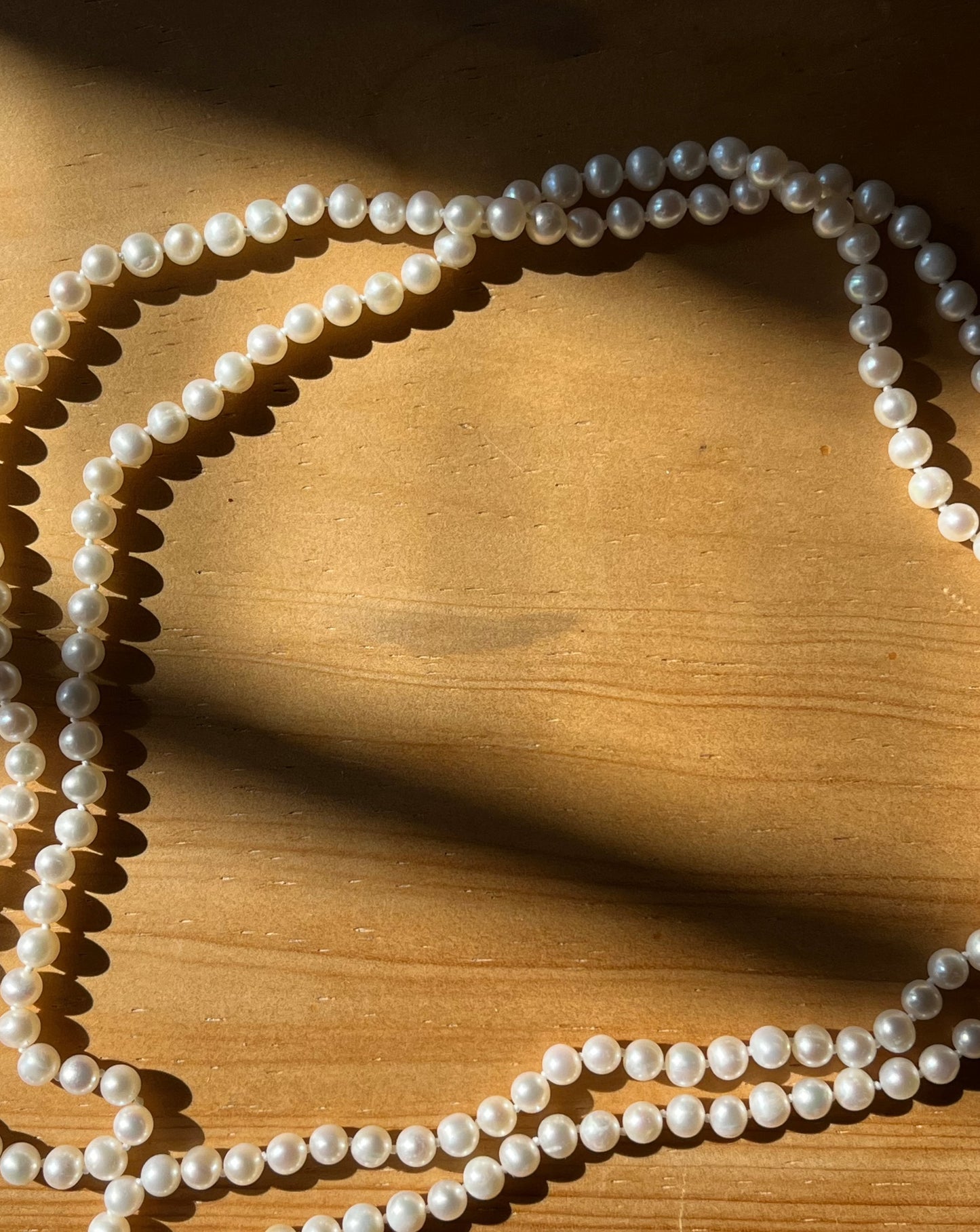 Vintage string of pearls worn by a woman