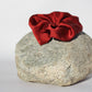 Red silk scrunchie on a rock