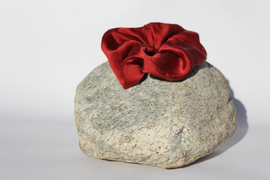 Red silk scrunchie on a rock