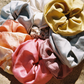 Rainbow Set of silk plant dyed scrunchies on the beach