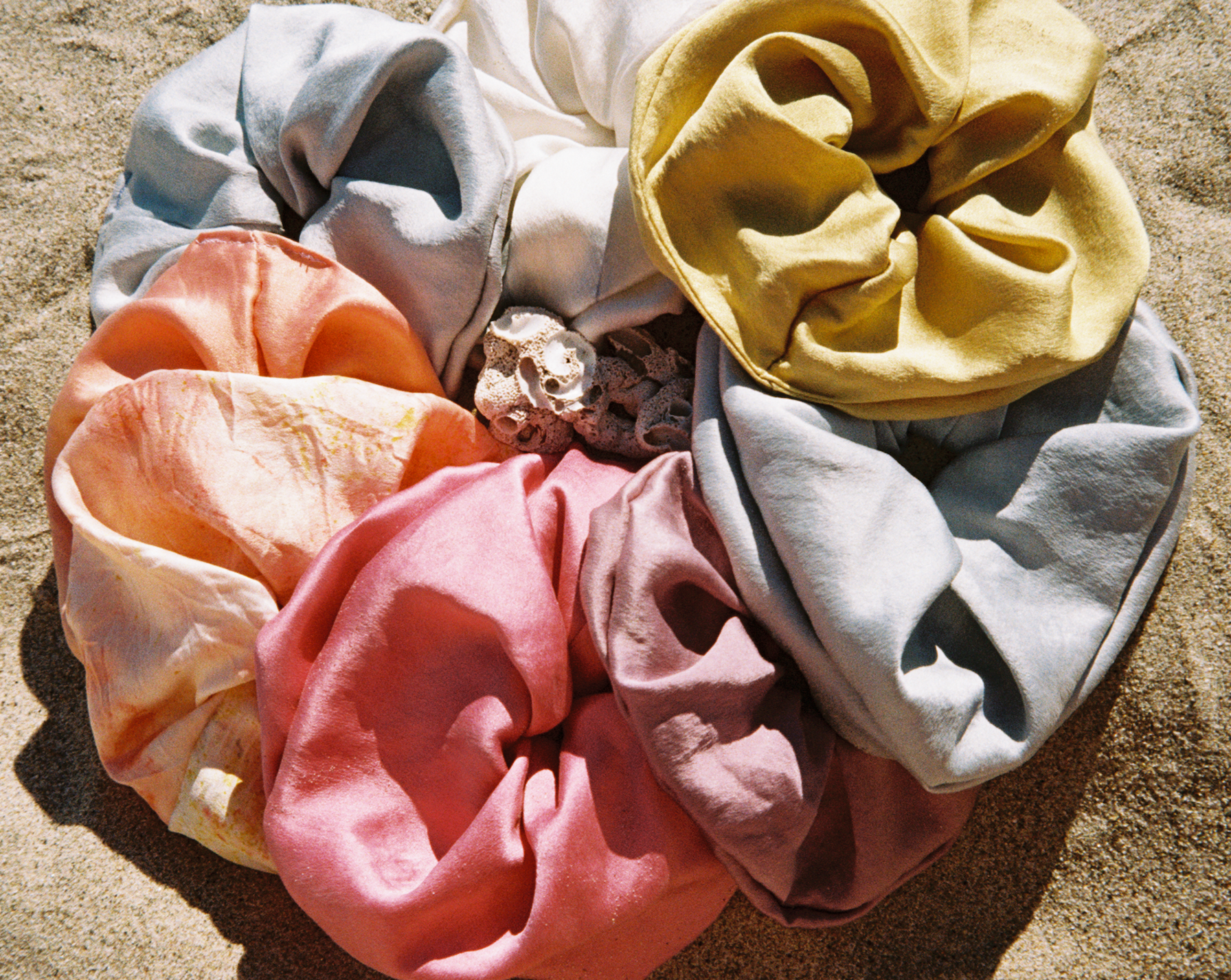 Rainbow Set of silk plant dyed scrunchies on the beach