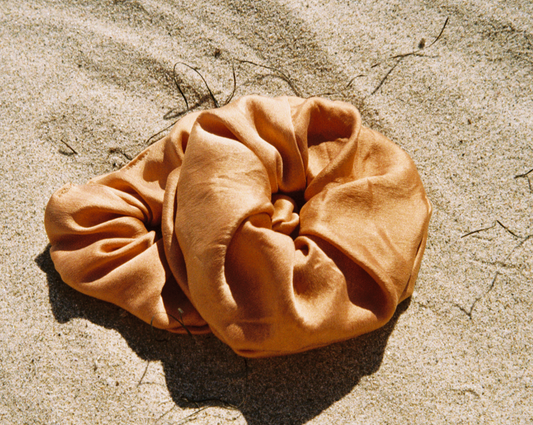 Warm brown silk scrunchie plant dyed with cutch bark made by Goose Summer in LA.