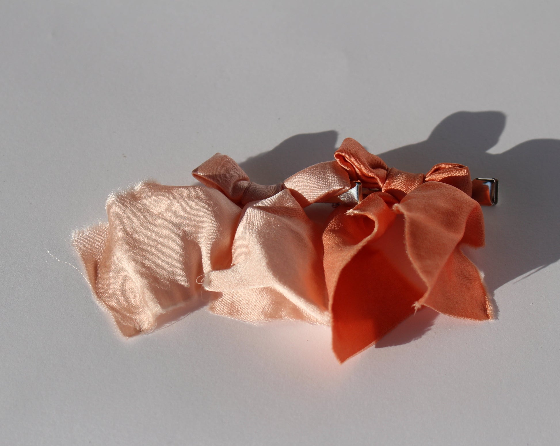 Two pink mini silk bows